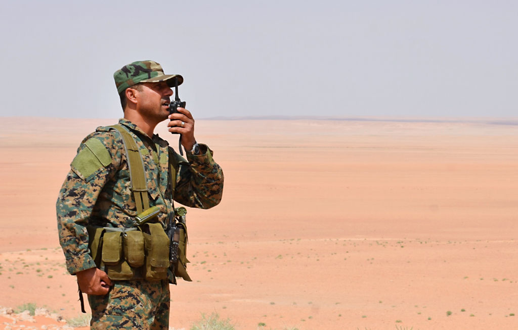 A member of the Syrian government forces talks on a walkie-talkie in Bir Qabaqib, more than 40 kilometres west of Deir Ezzor, after taking control of the area on their way to Kobajjep in the ongoing battle against Islamic State (IS) group jihadists on September 4, 2017.
Syria's army are fighting the Islamic State group on the edges of Deir Ezzor seeking to break the siege of a government enclave and oust the jihadists from a key stronghold. / AFP PHOTO / George OURFALIAN (Photo credit should read GEORGE OURFALIAN/AFP via Getty Images)