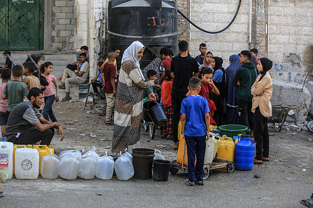 KHAN YUNIS, GAZA - JUNE 28: Palestinians try to meet their daily water needs by filling jerry cans from water tankers brought into the area in Khan Yunis, Gaza on June 28, 2025. In the Gaza Strip, which remains under Israeli attacks, Palestinians are struggling to survive under extremely harsh conditions, deprived of even the most basic necessities such as shelter, food, and clean water. (Photo by Abed Rahim Khatib/Anadolu via Getty Images)